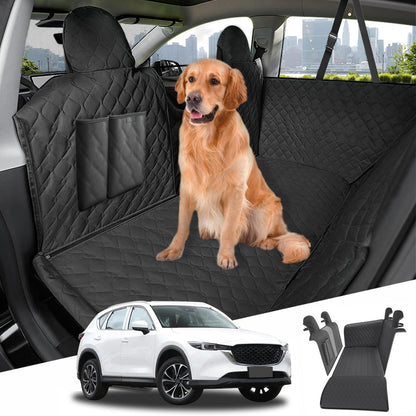 Dog sitting on a black car seat cover with a cityscape view, featuring a car and car seat cover in the foreground.